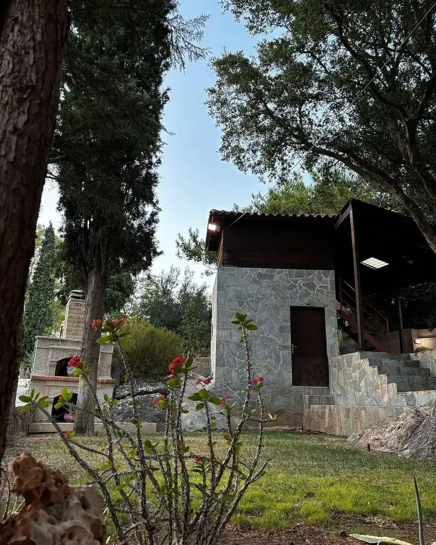 A stone-built property set in a garden, Elis Studio.