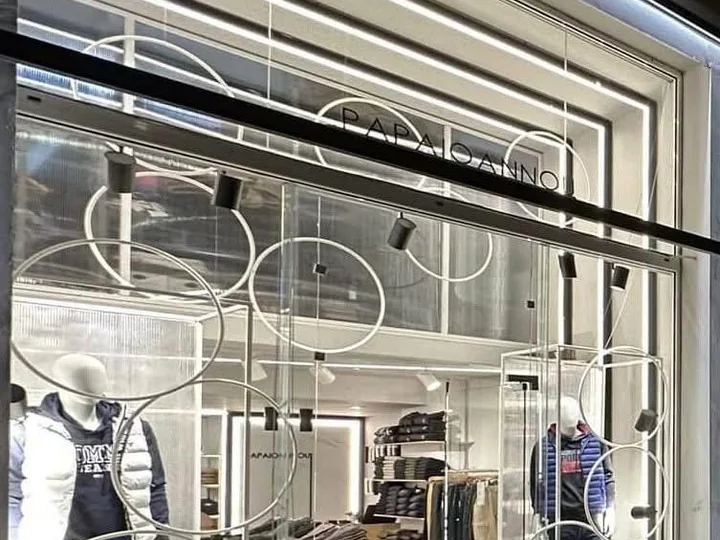 Inside the shop, with clothing racks.